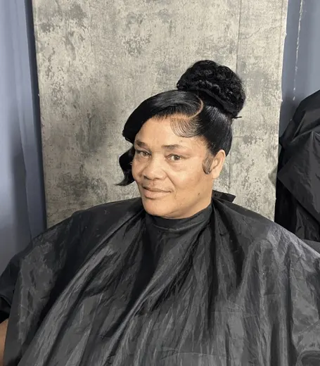 Sleek bun updo with swoop bang